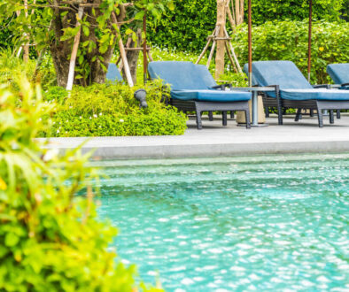 Beautiful outdoor swimming pool in hotel and resort with chair a