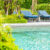 Beautiful outdoor swimming pool in hotel and resort with chair a