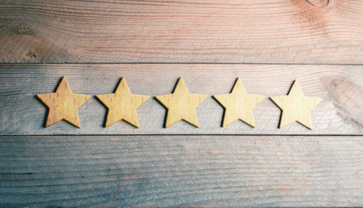 5 Golden Stars Lying Down On Wooden Board - View From Above - Top Quality Concept