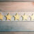 5 Golden Stars Lying Down On Wooden Board - View From Above - Top Quality Concept