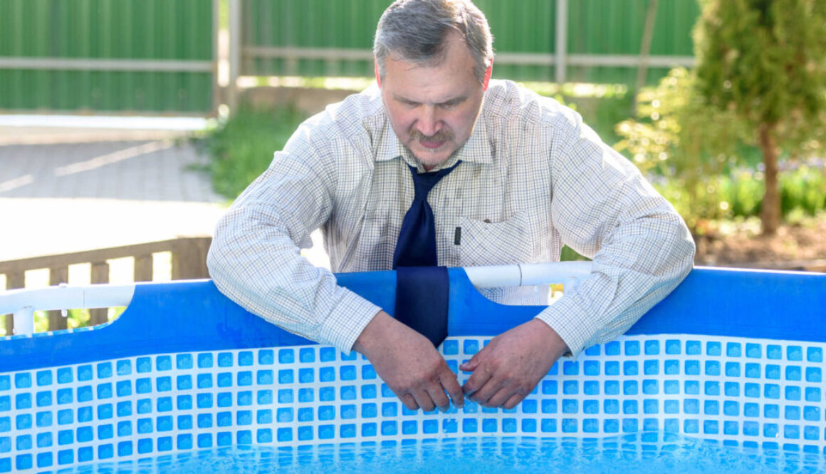 Handsome man in business suit by the pool