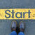 low-section-person-standing-by-text-road