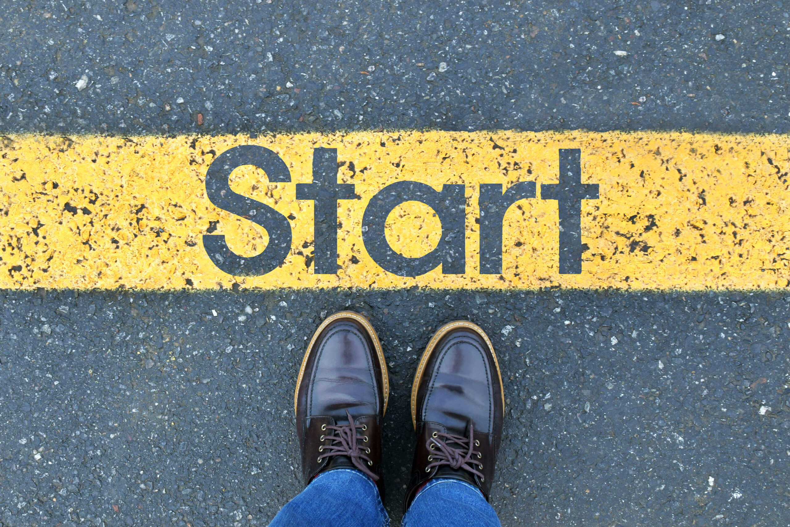 low-section-person-standing-by-text-road