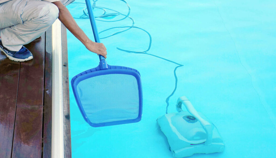 Hotel african staff worker cleaning the pool