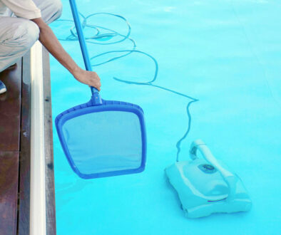 Hotel african staff worker cleaning the pool