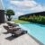 luxury-modern-villa-with-sun-loungers-by-poolside-tropical-sea-vacation-summer_0x800