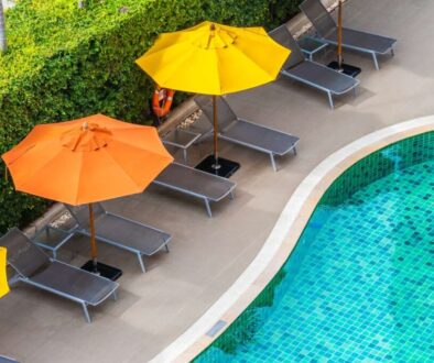 high-angle-view-lounge-chairs-by-swimming-pool_0x800