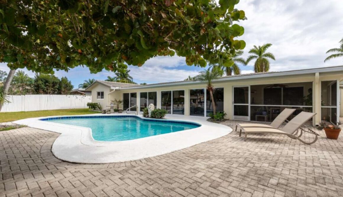 backyard-modern-house-with-swimming-pool-artificial-grass-stone-path-trees-chairs-umbre_0x800
