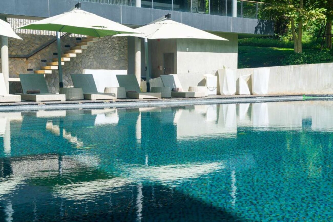 bed pool with umbrella around swimming pool