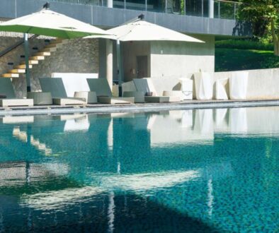 bed pool with umbrella around swimming pool