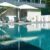 bed pool with umbrella around swimming pool