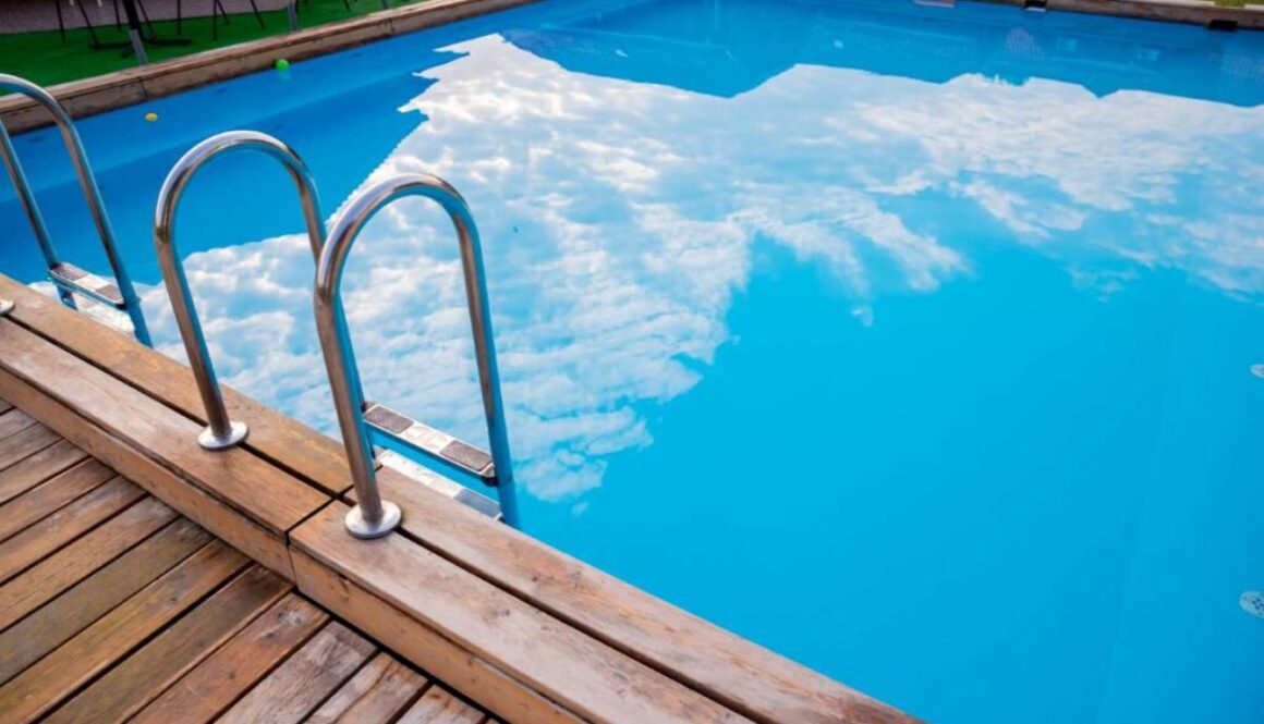 Ladder stainless handrails for descent into swimming pool.