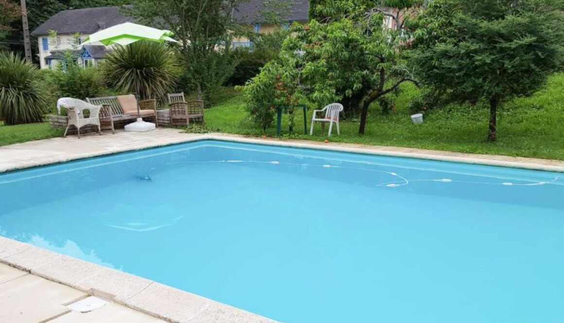 Outdoor swimming pool with blue water near the garden