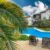palm-trees-by-swimming-pool-against-building_0x800