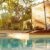 panorama-luxury-swimming-pool-modern-villa-with-palm-trees-wooden-lounge-chairs-sunset_0x800