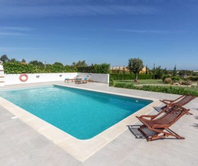 Sun bath with sun loungers and parasol. In Portugal.