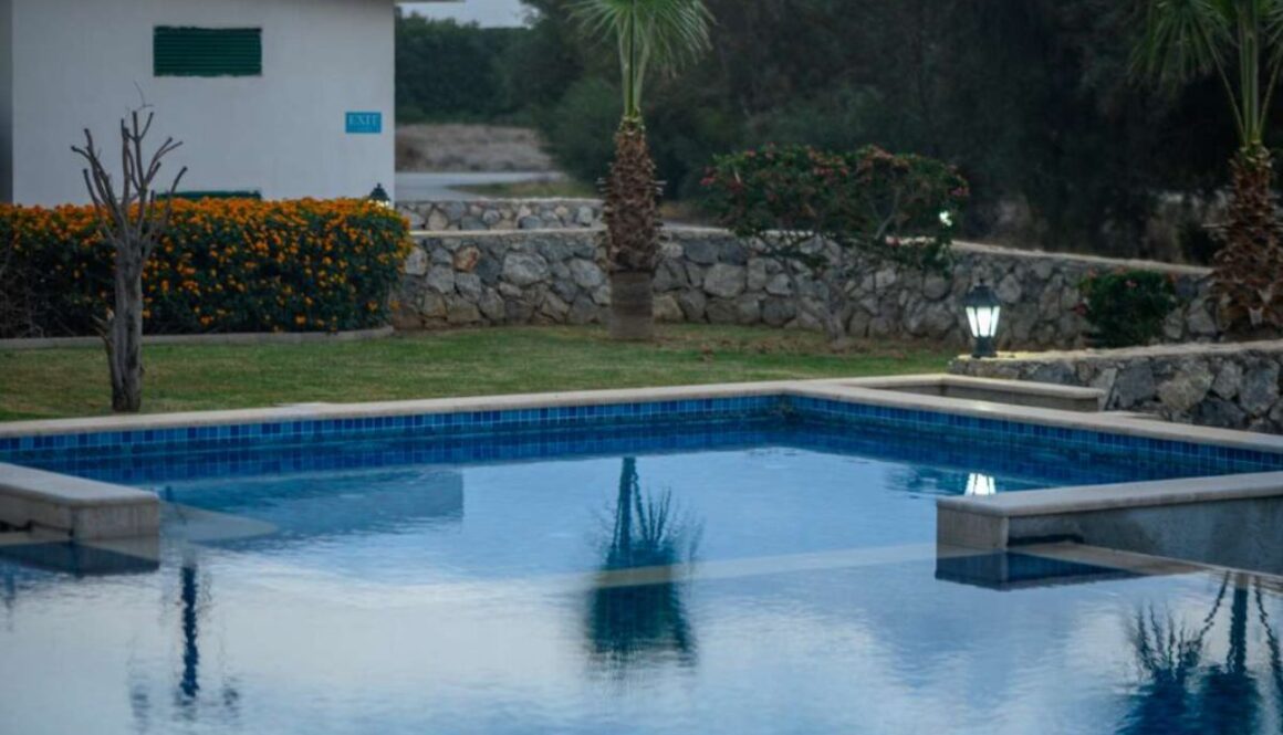 swimming pool near a house in a residential complex at sunset 3