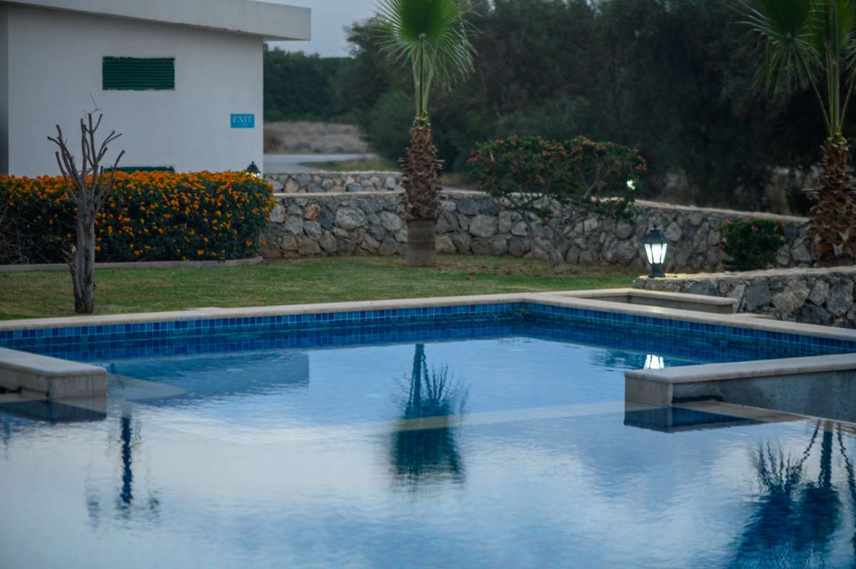 swimming pool near a house in a residential complex at sunset 3