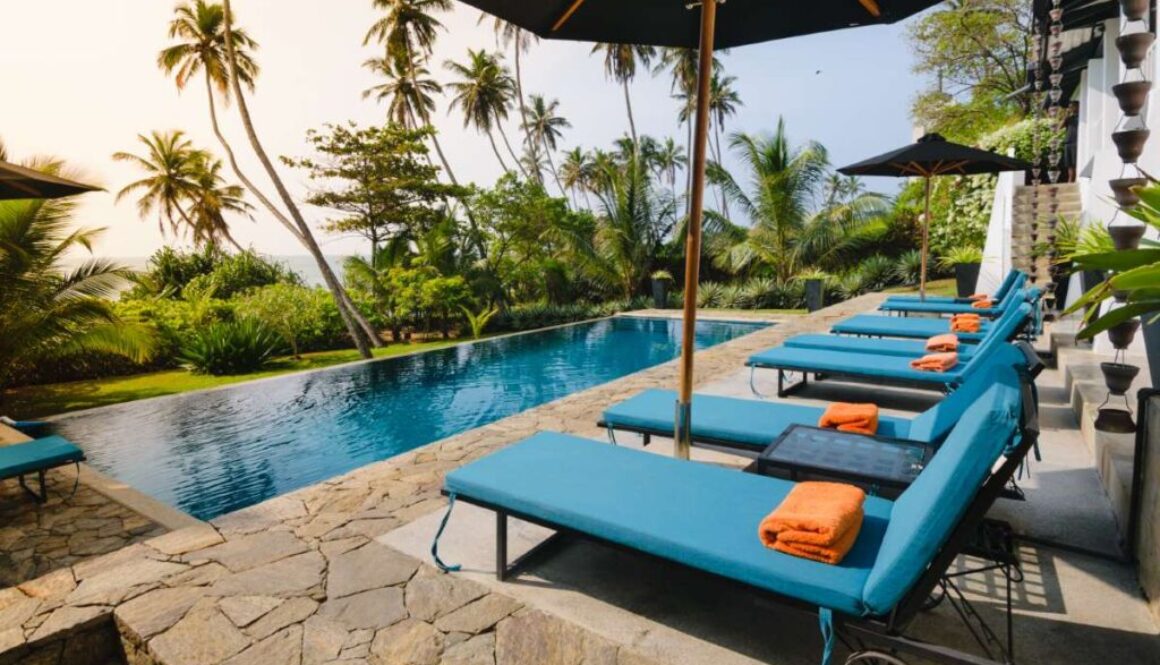 Swimming pool and lounge chairs in boutique hotel, Sri Lanka