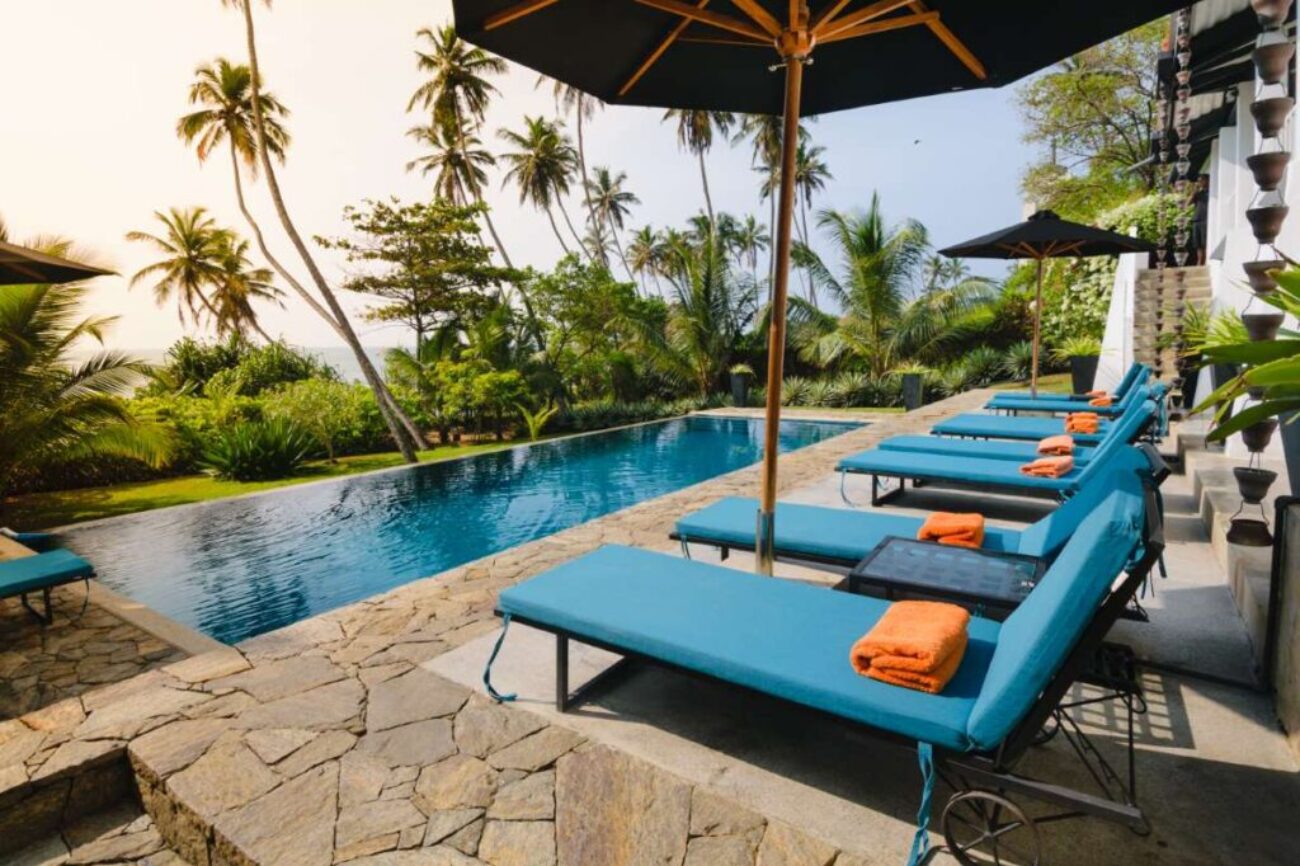 Swimming pool and lounge chairs in boutique hotel, Sri Lanka