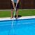 action-cleaning-bottom-pool-house-villa-man-holding-pool-cleaner-rod_0x800