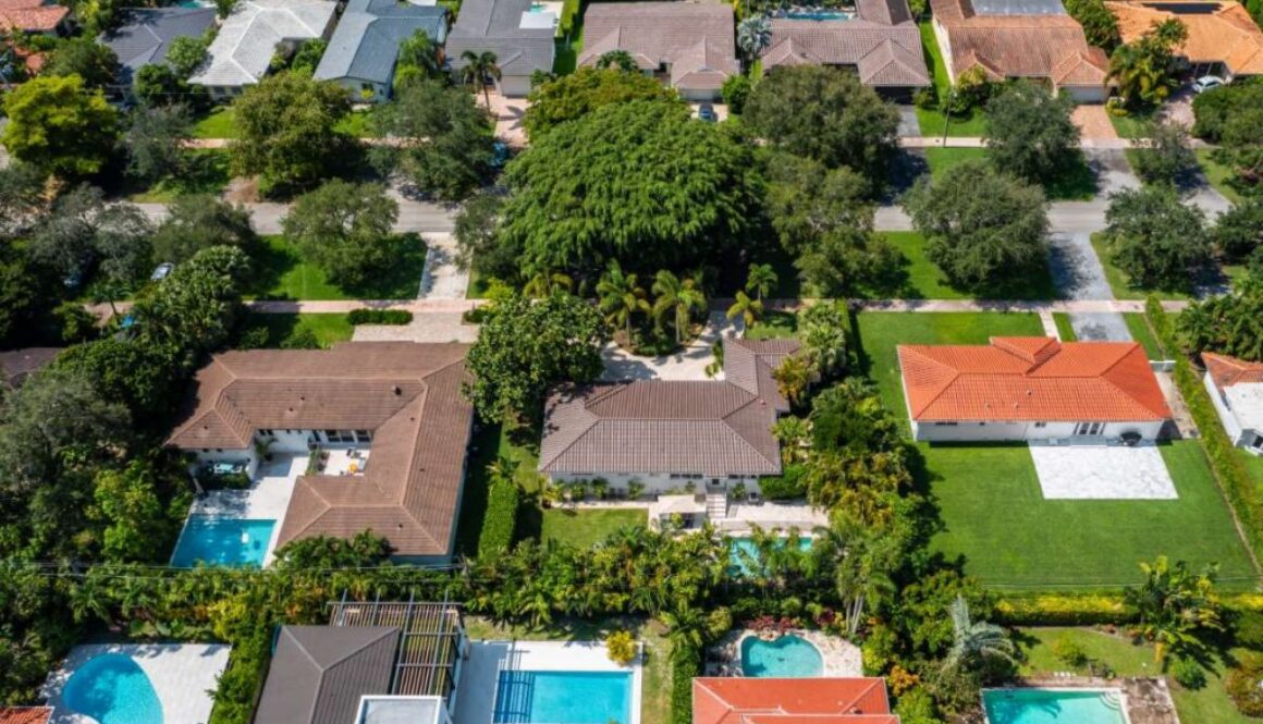 aerial-drone-photoshoot-commercial-area-tropical-vegetation-blue-sky-water-canal_0x800