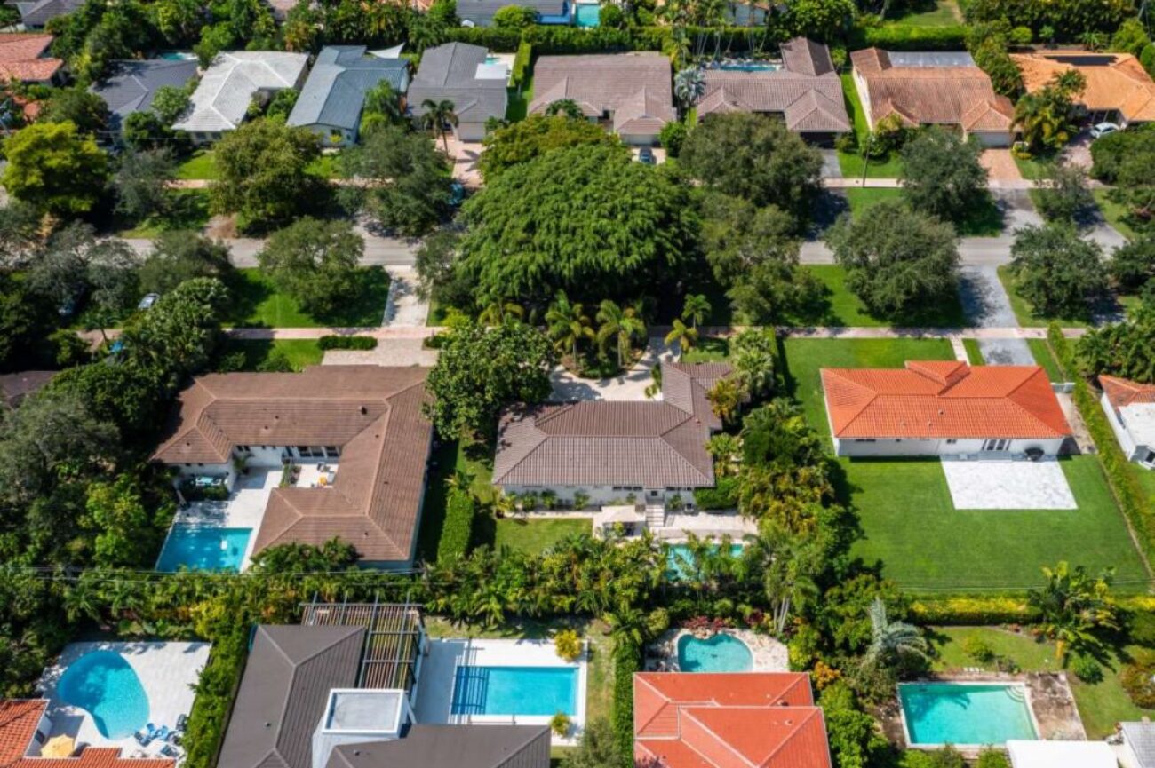 aerial-drone-photoshoot-commercial-area-tropical-vegetation-blue-sky-water-canal_0x800