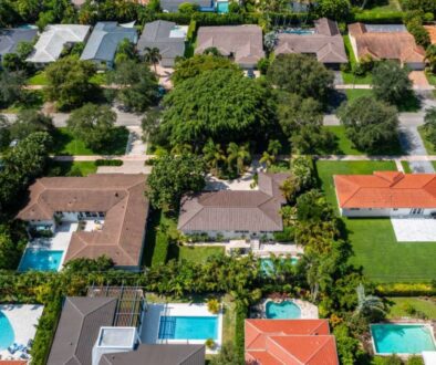 aerial-drone-photoshoot-commercial-area-tropical-vegetation-blue-sky-water-canal_0x800