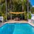 backyard-modern-house-with-swimming-pool-artificial-grass-stone-path-trees-chairs(1)_0x800 (1)