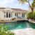 backyard-modern-house-with-swimming-pool-artificial-grass-stone-path-trees-chairs(2)_0x800