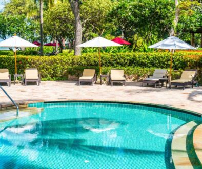 beautiful-tropical-beach-sea-with-umbrella-chair-around-swimming-pool-hotel-resort_0x800