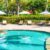 beautiful-tropical-beach-sea-with-umbrella-chair-around-swimming-pool-hotel-resort_0x800
