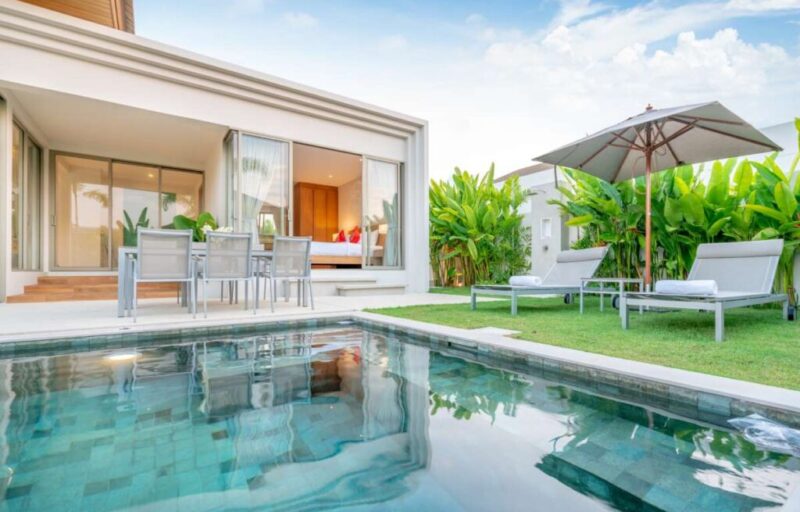 home-house-exterior-design-showing-tropical-pool-villa-with-greenery-garden-sun-bed-umbrella-pool-towels_0x800