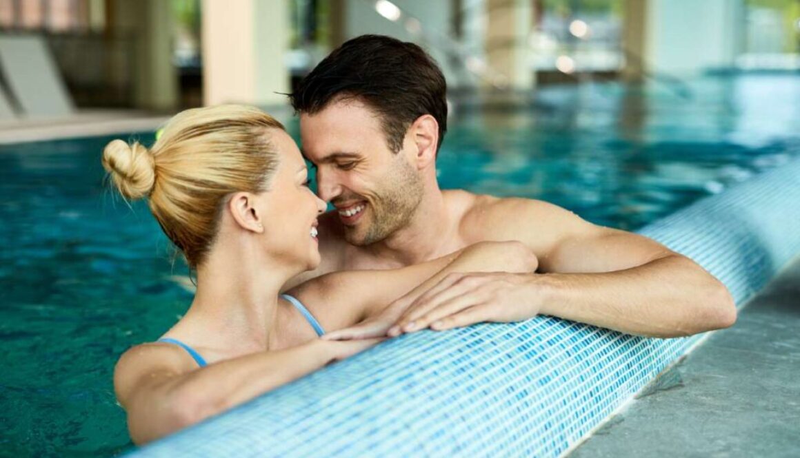 loving-couple-talking-face-face-while-being-water-indoor-swimming-pool-spa_0x800