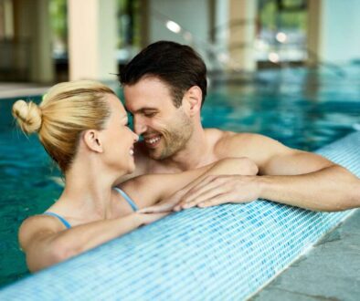 loving-couple-talking-face-face-while-being-water-indoor-swimming-pool-spa_0x800