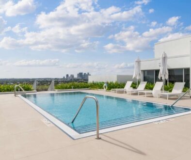 modern-building-with-swimming-pool-trees-chairs-urban-landscape-with-blue-sky-reflecting-pool(1)_0x800