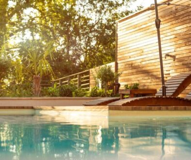 panorama-luxury-swimming-pool-modern-villa-with-palm-trees-wooden-lounge-chairs-sunset_0x800