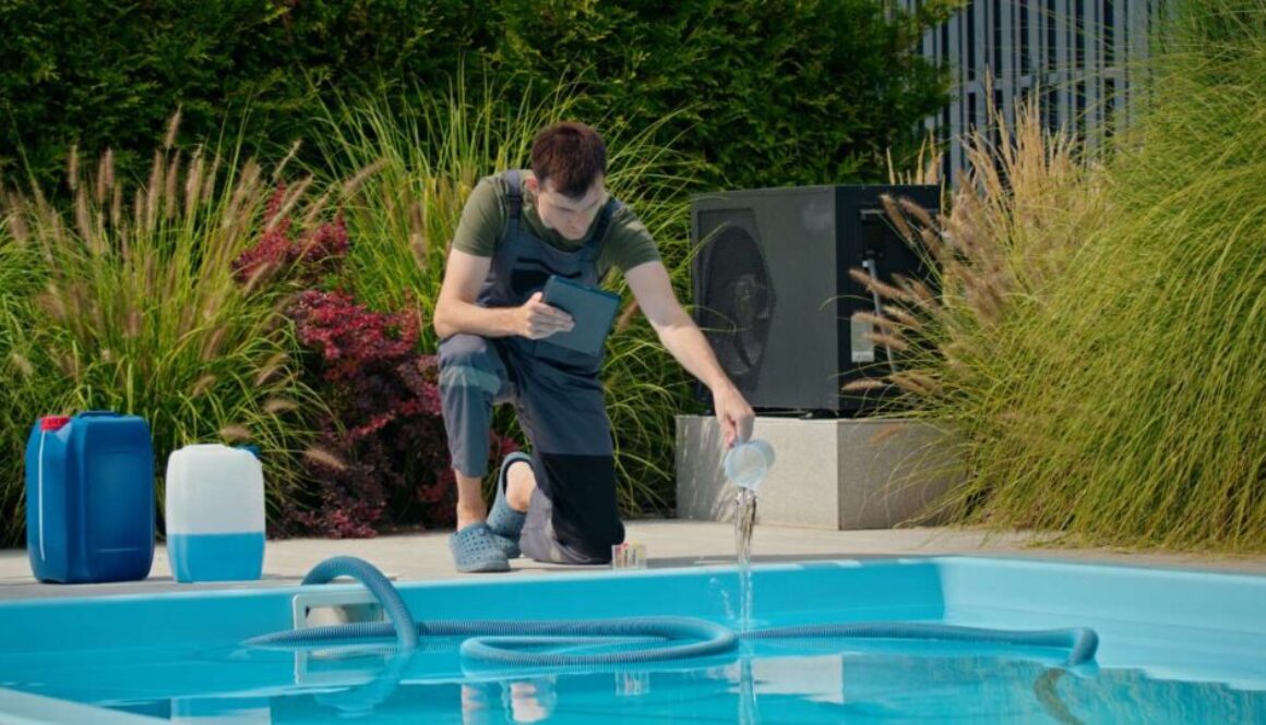 pool-technician-pouring-liquid-into-pool-while-using-tablet-surrounded-by-chemical-containers_0x800