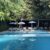 pool-with-pool-with-blue-water-umbrellas-chairs_0x800