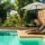 swimming-pool-modern-private-villa-with-lounge-chairs-palm-trees-umbrella(1)_0x800