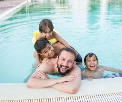 young-boy-kid-child-splashing-swimming-pool-having-fun-leisure-activity_0x800