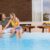 young-couple-relaxing-by-swimming-pool-house-backyard_0x800