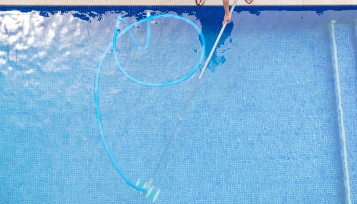 top view of man cleaning a swimming pool