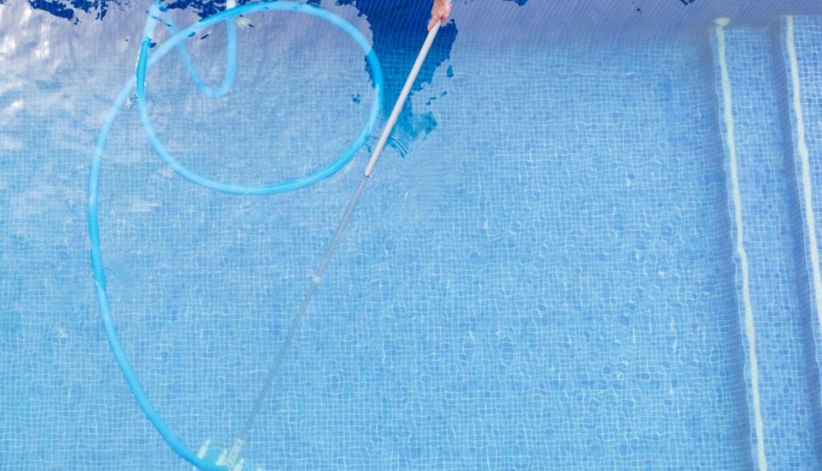 top view of man cleaning a swimming pool