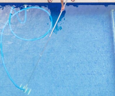 top view of man cleaning a swimming pool