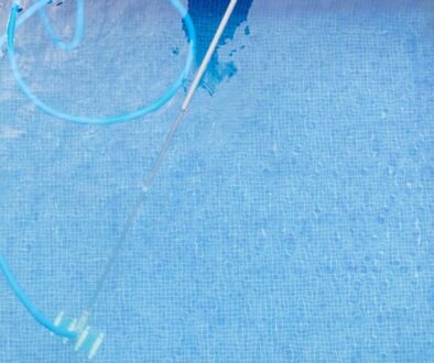 top view of man cleaning a swimming pool