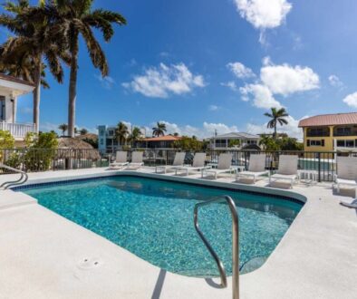 modern-building-with-swimming-pool-trees-chairs-landscape-with-blue-sky-scenic-enviroment_0x800