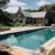 swimming-pool-with-house-background_0x800