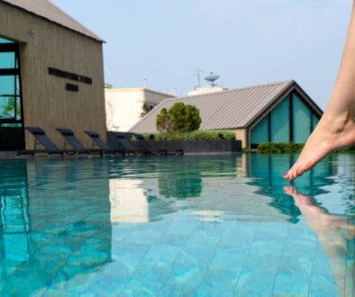 close-up-girl-s-leg-descends-into-pool-foot-touches-water-checks-water-temperature-before-swimming_0x800