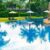 empty-beach-chair-with-umbrella-around-swimming-pool_0x800